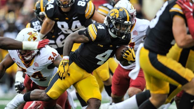 Sep 10, 2022; Iowa City, Iowa, USA; Iowa Hawkeyes running back Leshon Williams (4) scores on a 9 yard touchdown run as Iowa State Cyclones linebacker O'Rien Vance (34) attempts to make the tackle during the first quarter at Kinnick Stadium. Mandatory Credit: Jeffrey Becker-USA TODAY Sports